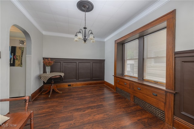 interior space featuring ornamental molding, a chandelier, and dark wood-type flooring