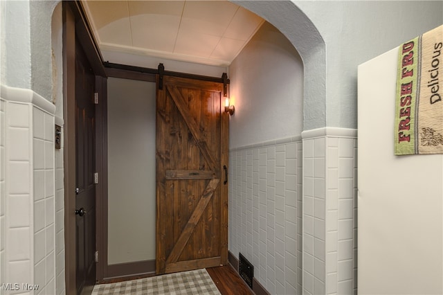 hallway with hardwood / wood-style flooring and a barn door