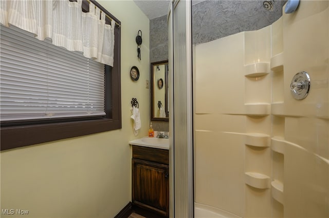 bathroom with a shower and vanity