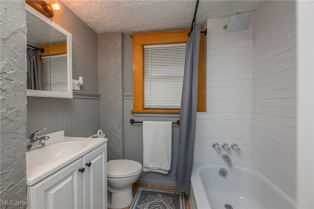 full bathroom with a textured ceiling, vanity, toilet, and shower / bath combination with curtain