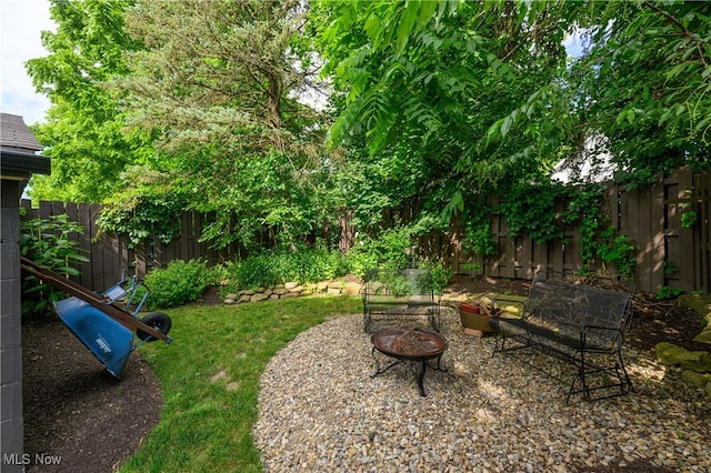 view of yard with a patio and a fire pit