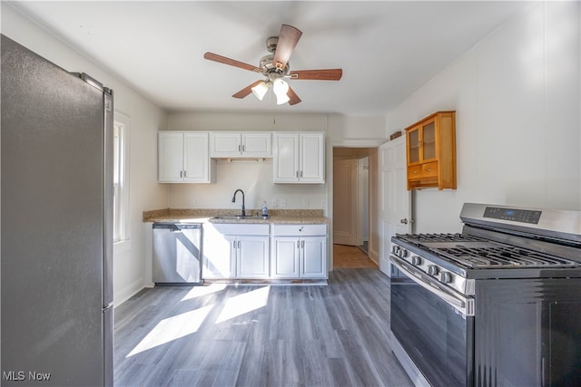 kitchen featuring ceiling fan, white cabinets, sink, appliances with stainless steel finishes, and dark hardwood / wood-style flooring