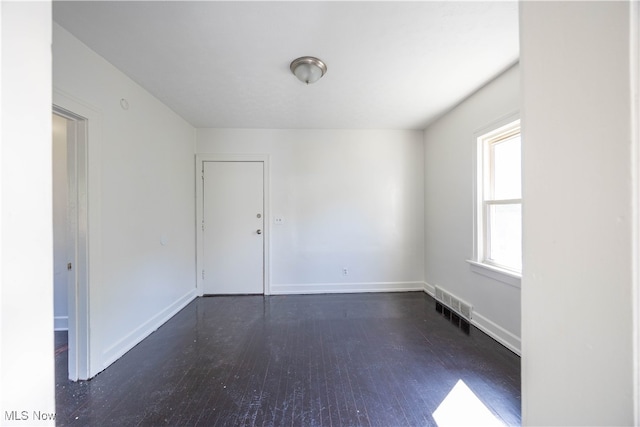 empty room featuring dark hardwood / wood-style floors