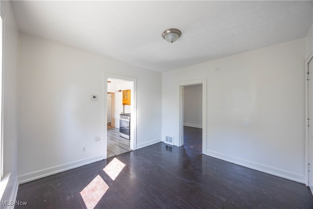 spare room with dark wood-type flooring