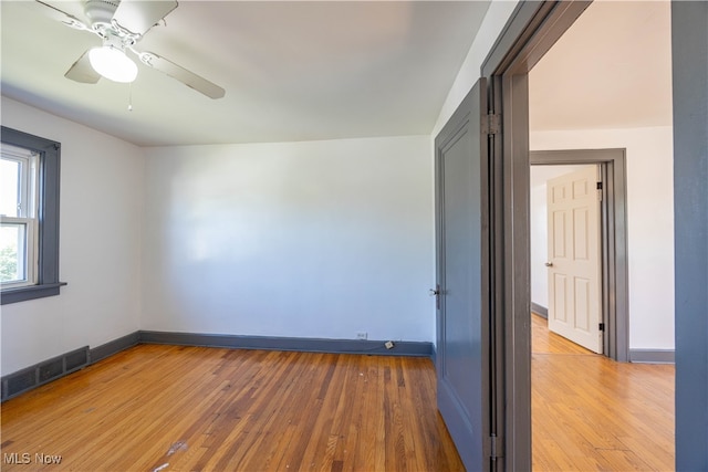 empty room featuring ceiling fan and hardwood / wood-style flooring