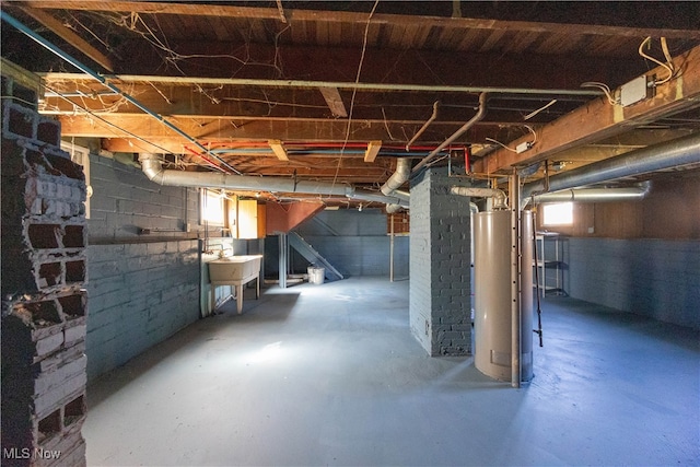 basement with gas water heater and sink