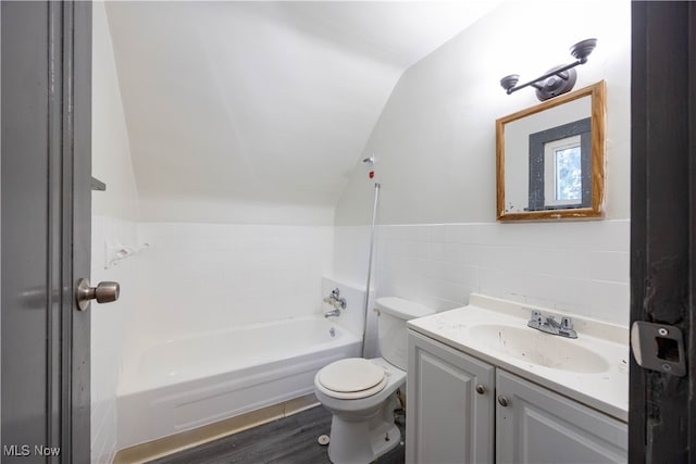 full bathroom with vanity, lofted ceiling, wood-type flooring, tile walls, and toilet