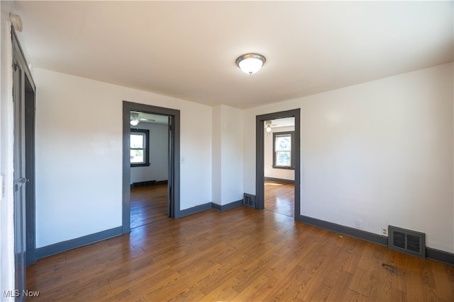 empty room featuring dark hardwood / wood-style floors and a wealth of natural light