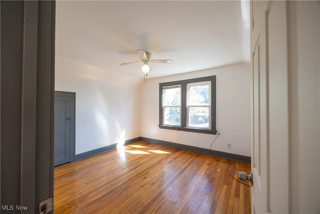 empty room with wood-type flooring and ceiling fan