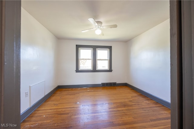 unfurnished room featuring ceiling fan and dark hardwood / wood-style flooring