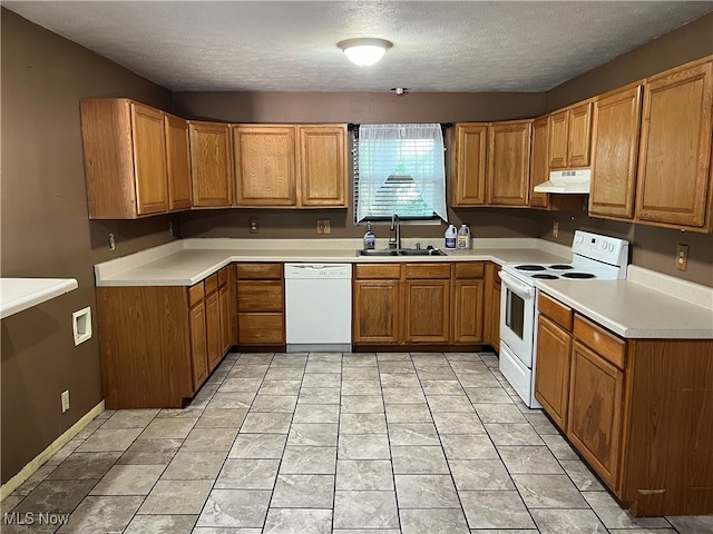 kitchen featuring a textured ceiling, sink, and white appliances