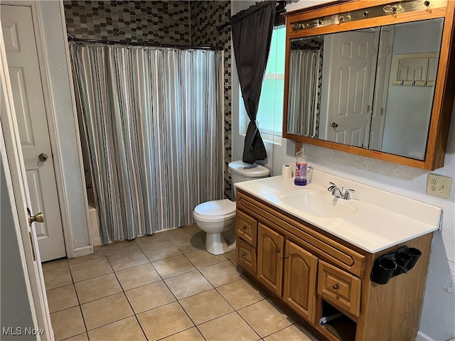 bathroom featuring tile patterned flooring, vanity, and toilet