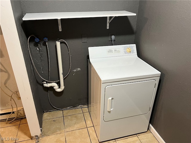 laundry area featuring washer / clothes dryer and light tile patterned floors