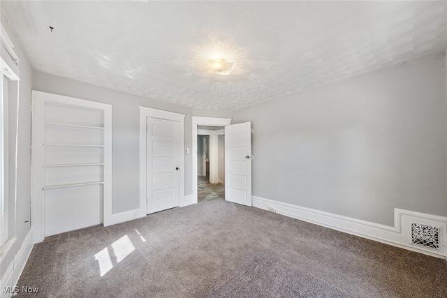 unfurnished bedroom with carpet floors