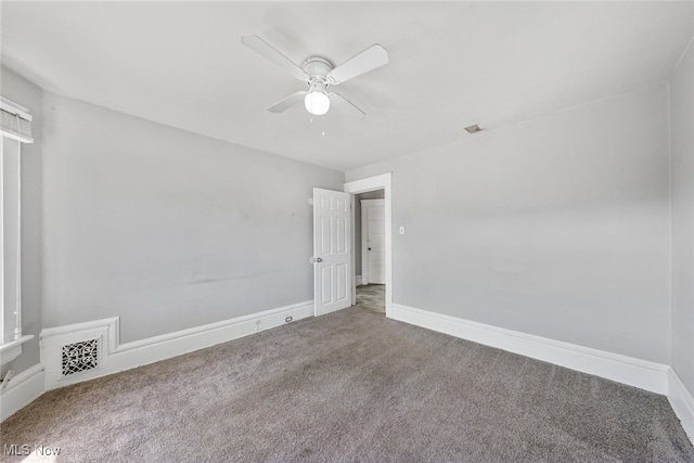 spare room featuring ceiling fan and carpet flooring