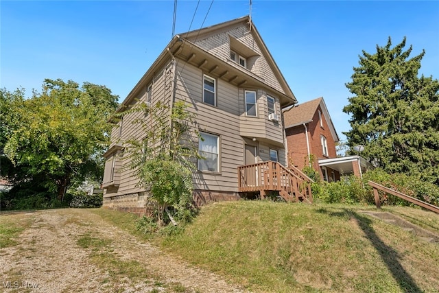 rear view of house with a yard