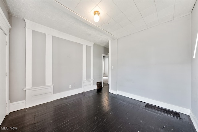 unfurnished room featuring dark hardwood / wood-style floors