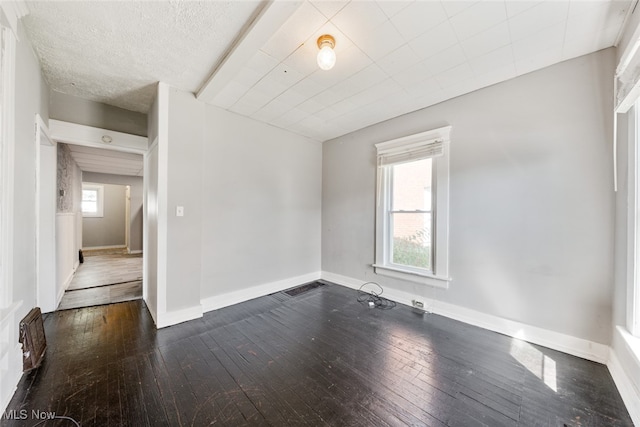 spare room featuring dark wood-type flooring