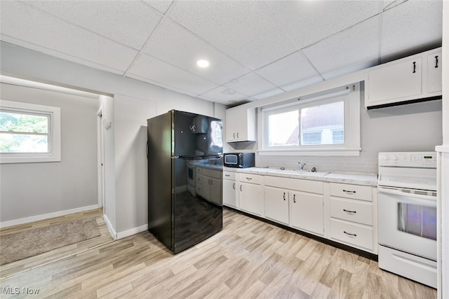 kitchen featuring white cabinets, light hardwood / wood-style flooring, sink, and black appliances