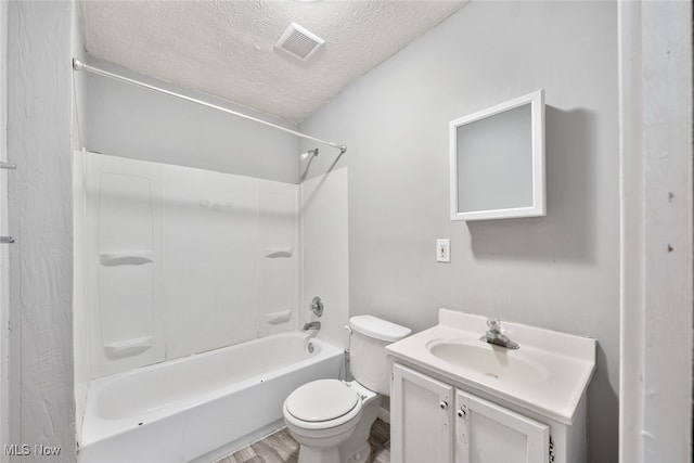 full bathroom featuring vanity, bathtub / shower combination, wood-type flooring, a textured ceiling, and toilet