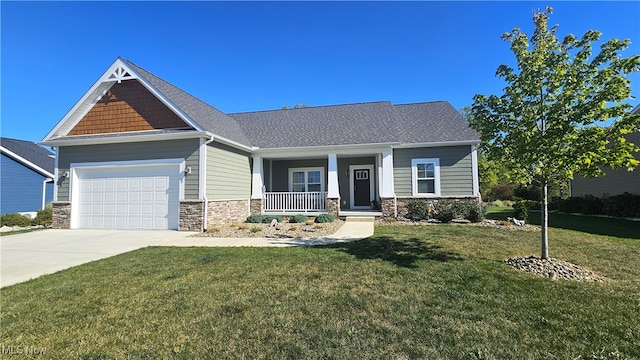 craftsman inspired home featuring a garage, a porch, and a front lawn