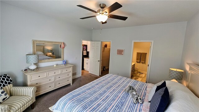 bedroom with dark colored carpet, ensuite bath, and ceiling fan