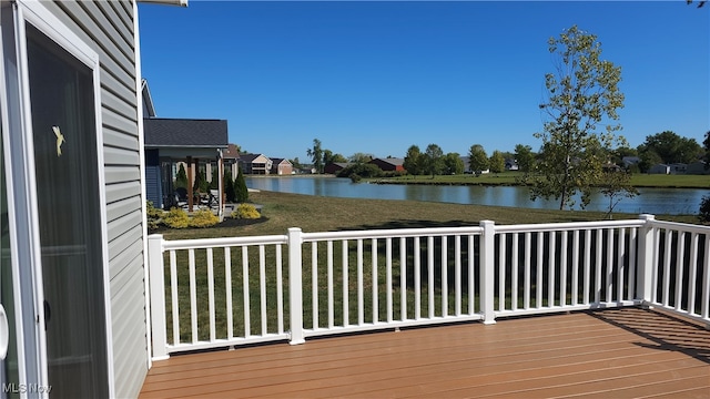 wooden deck featuring a yard and a water view