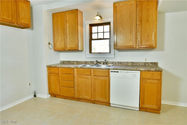 kitchen with dishwasher, light tile patterned floors, and sink