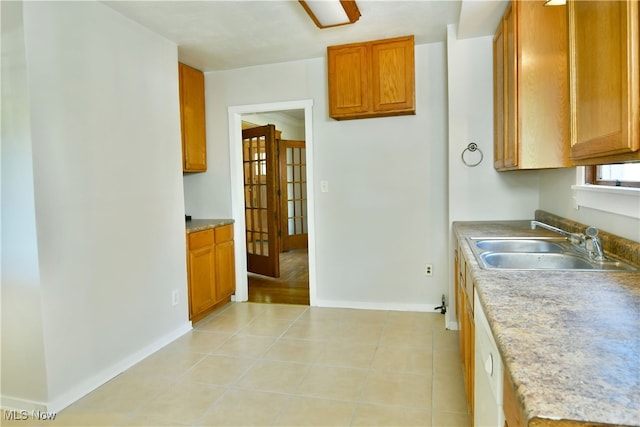 kitchen with light tile patterned flooring and sink