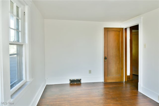 unfurnished room with dark hardwood / wood-style floors