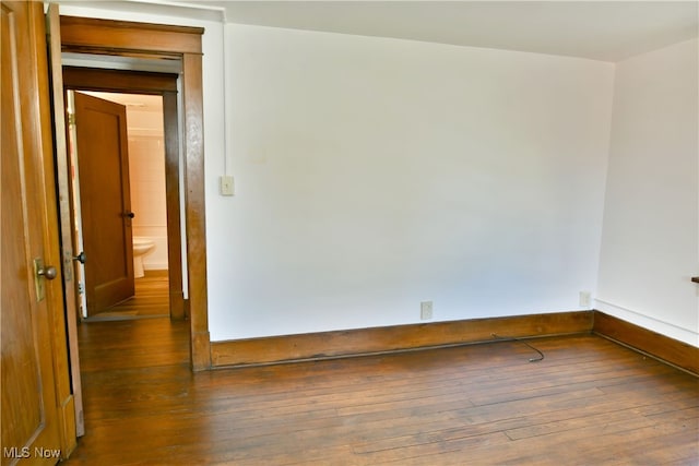 unfurnished room featuring dark hardwood / wood-style floors