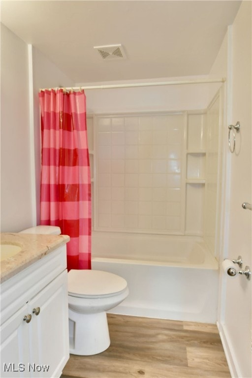 full bathroom featuring shower / tub combo, hardwood / wood-style flooring, vanity, and toilet