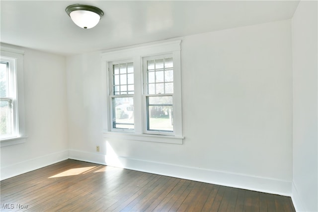 spare room featuring dark hardwood / wood-style flooring