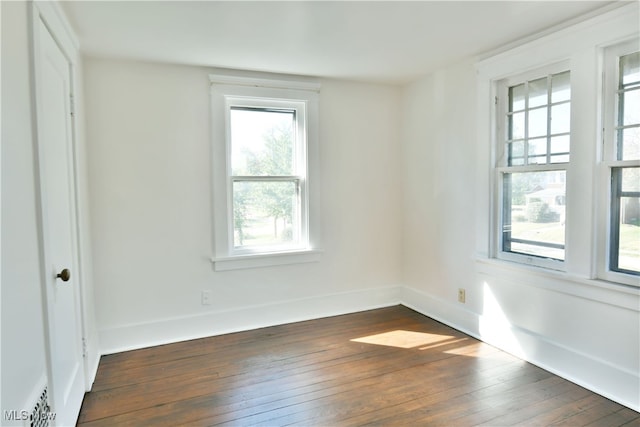 empty room featuring dark wood-type flooring