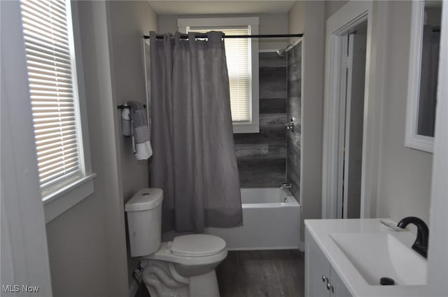 full bathroom featuring vanity, toilet, wood-type flooring, and shower / tub combo