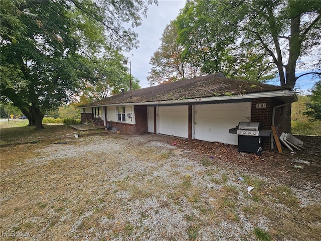 view of side of home featuring a garage