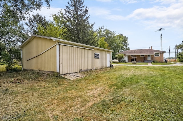 view of outbuilding featuring a yard