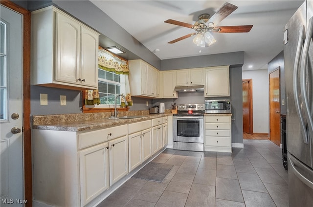 kitchen featuring ceiling fan, cream cabinets, stainless steel appliances, and sink