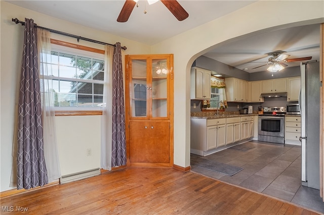 kitchen featuring dark hardwood / wood-style floors, ceiling fan, stainless steel appliances, and sink