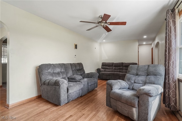 living room featuring hardwood / wood-style floors and ceiling fan