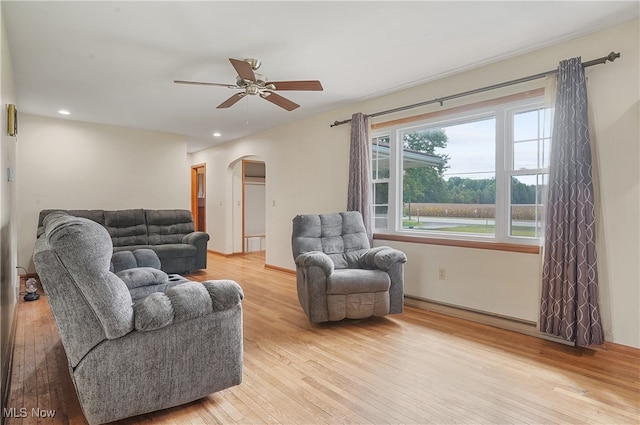 living room featuring light hardwood / wood-style floors and ceiling fan