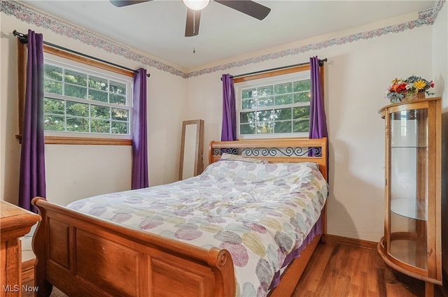 bedroom with ceiling fan and hardwood / wood-style flooring