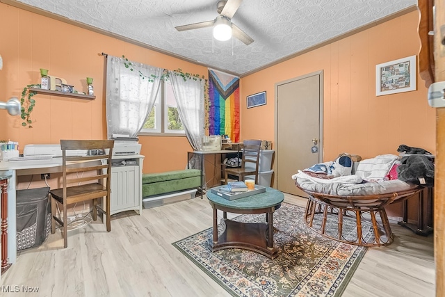 office with ceiling fan, ornamental molding, a textured ceiling, and light hardwood / wood-style floors