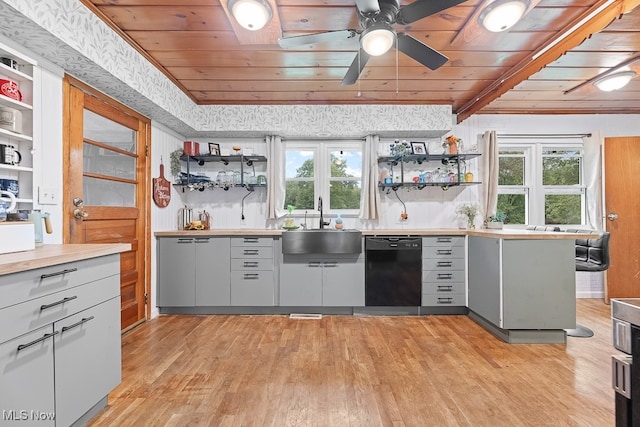 kitchen featuring light wood-type flooring, dishwasher, sink, and plenty of natural light