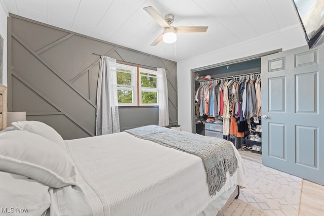 bedroom featuring ceiling fan, a closet, and light hardwood / wood-style flooring