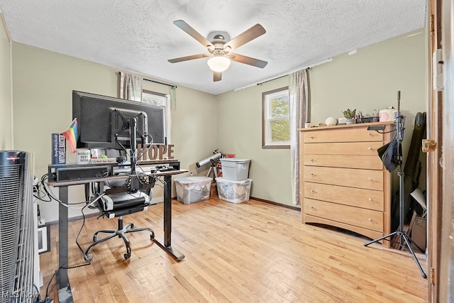 office space with wood-type flooring, a textured ceiling, and ceiling fan