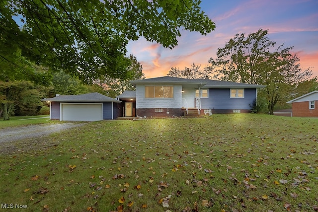 view of front facade featuring a garage and a lawn