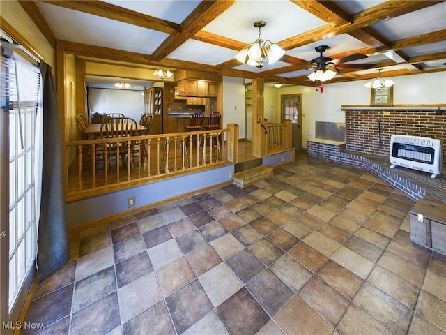 unfurnished living room featuring beamed ceiling, coffered ceiling, and heating unit