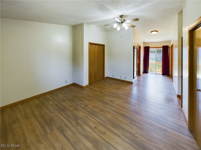 spare room featuring ceiling fan, a textured ceiling, and dark wood-type flooring