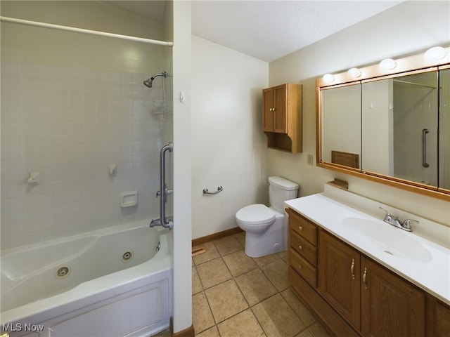 full bathroom featuring tiled shower / bath combo, tile patterned flooring, vanity, and toilet